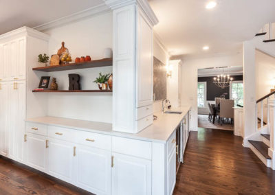 kitchen remodel simply white quartz brass curved banquette staircase remodel square baluster square newel post blue island