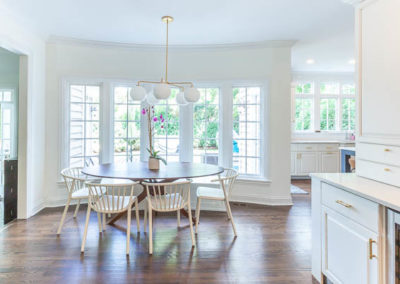 kitchen remodel simply white quartz brass curved banquette staircase remodel square baluster square newel post blue island