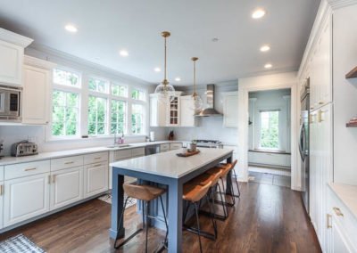 kitchen remodel simply white quartz brass curved banquette staircase remodel square baluster square newel post blue island