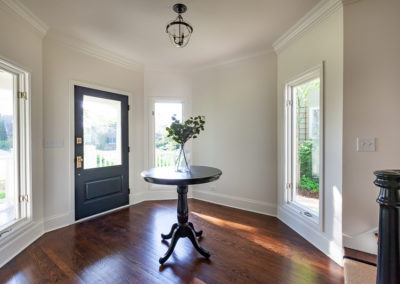 eclectic front door window pane on top dark gray door brass hardware stair refinish