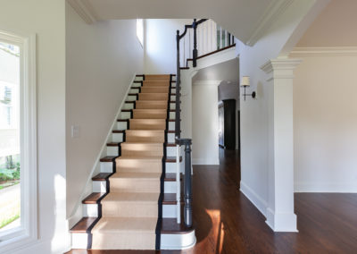 eclectic front door window pane on top dark gray door brass hardware stair refinish