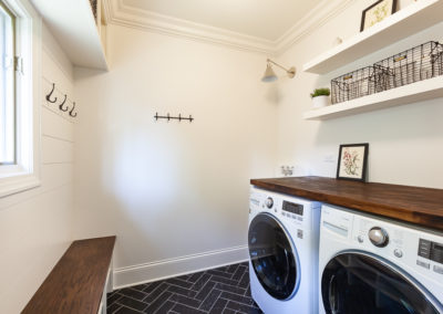 mudroom bench hooks laundry room wood top simple design dark gray tile