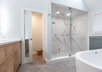 master bathroom remodel quartz surround free standing soaker tub porcelain floor bleached walnut vanity lit mirror contemporary clarendon hills illinois