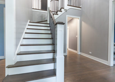 staircase remodel wood tread white riser stained newel post top iron baluster clarendon hills illinois