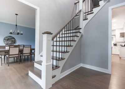 staircase remodel wood tread white riser stained newel post top iron baluster clarendon hills illinois