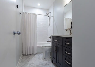 navy vanity hallway bathroom remodel tub hyland homes chicago illinois