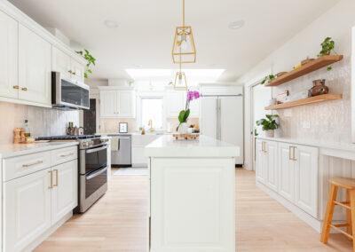Open-concept kitchen remodel in Hinsdale with new base cabinets, large island, and light refinished hardwood floors