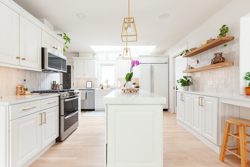Open-concept kitchen remodel in Hinsdale with new base cabinets, large island, and light refinished hardwood floors