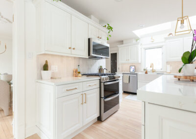 Open-concept kitchen remodel in Hinsdale with new base cabinets, large island, and light refinished hardwood floors