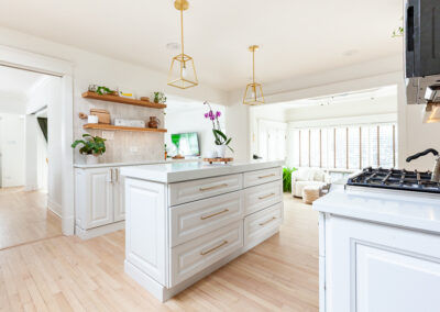 Open-concept kitchen remodel in Hinsdale with new base cabinets, large island, and light refinished hardwood floors